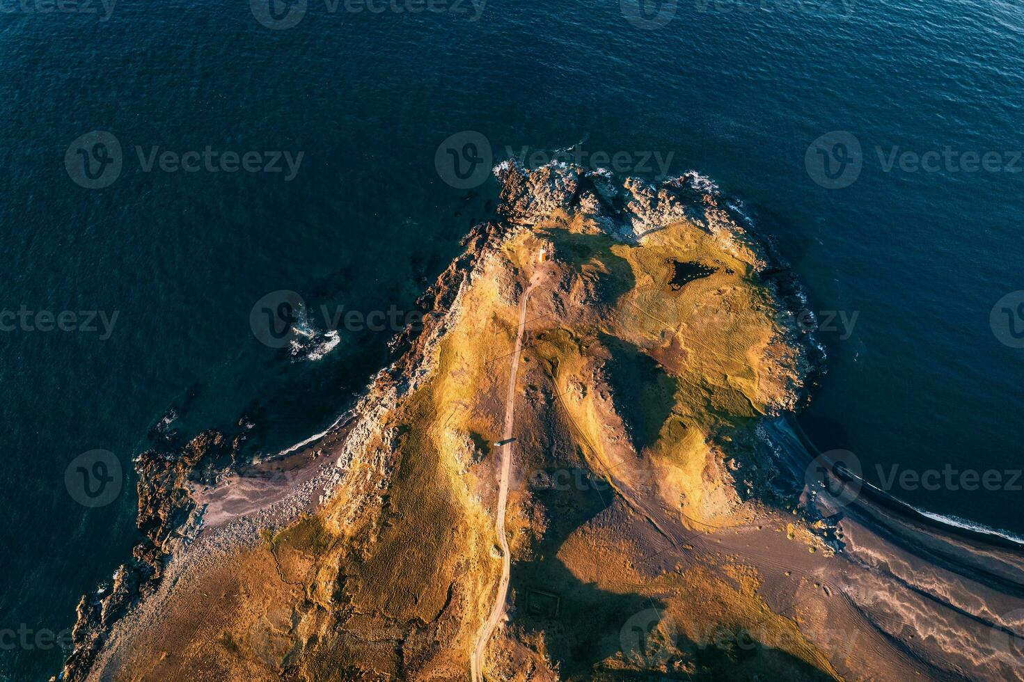 Road to lighthouse by coastline on summer at Iceland photo