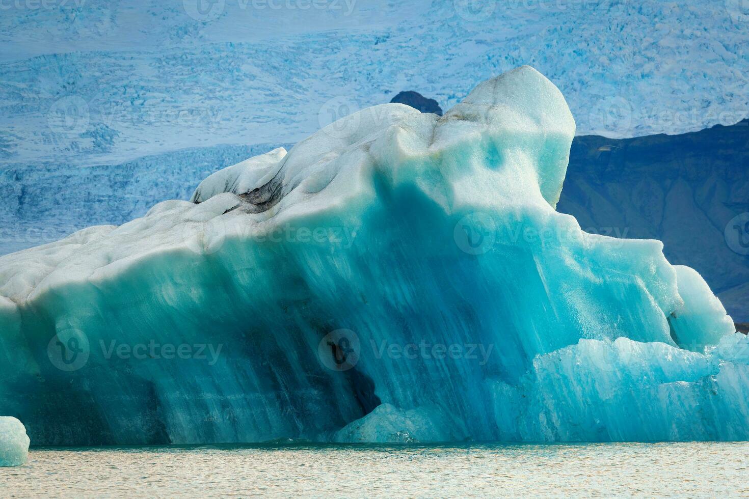 Abstract pattern of blue iceberg melting and floating in Jokulsarlon glacier lagoon on summer at Iceland photo