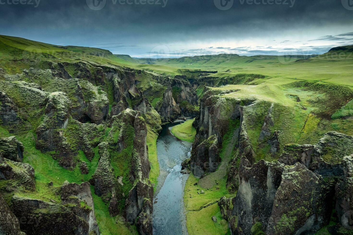 Stunning view of Fjadrargljufur canyon naturally eroded with Fjadra flowing through ravine in summer at Iceland photo