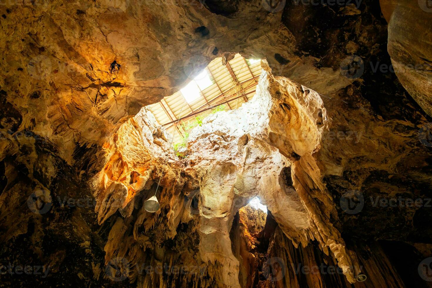 Large cavity limestone cave sunlight shine under earth photo