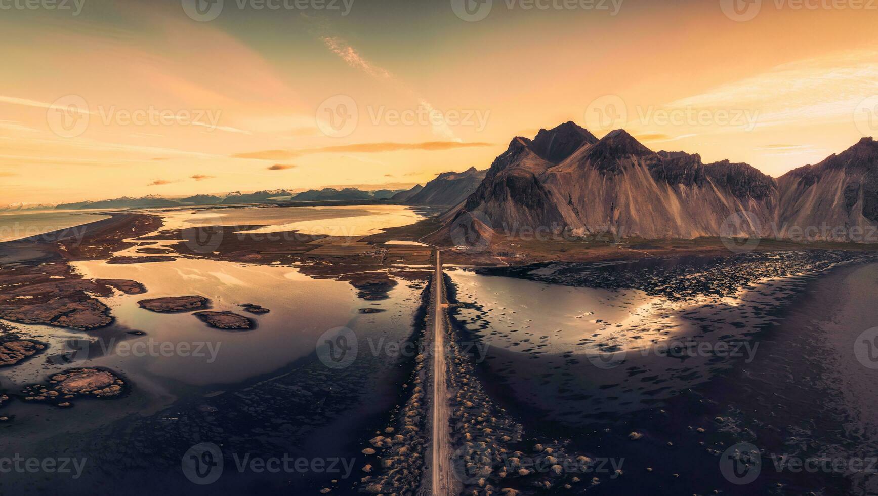 Beautiful sunrise over Vestrahorn mountain viking village and road among black sand beach in Stokksnes on summer at Iceland photo