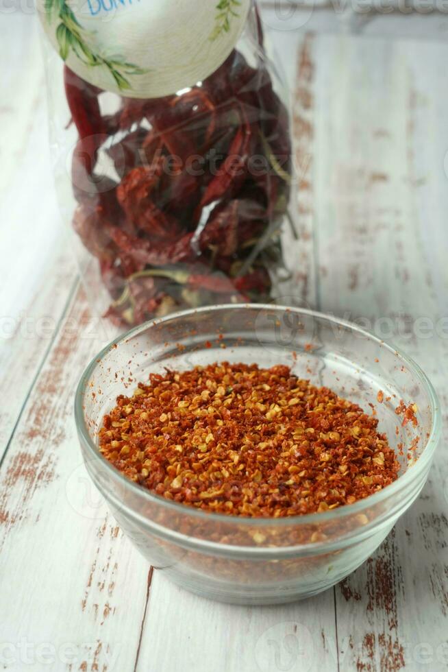 top view of chili flakes in a bowl on table photo