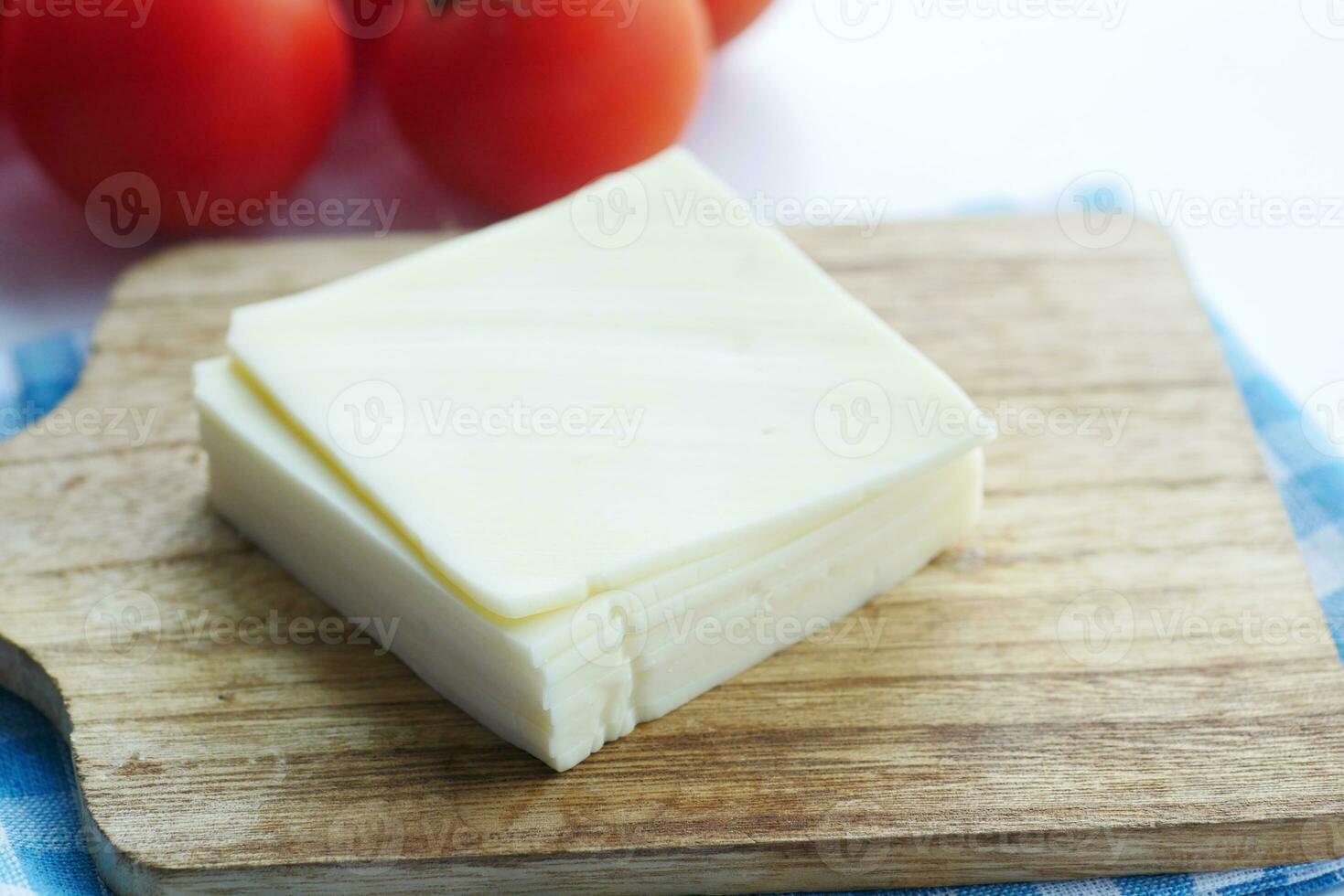 Slicing cheese into pieces closeup, photo