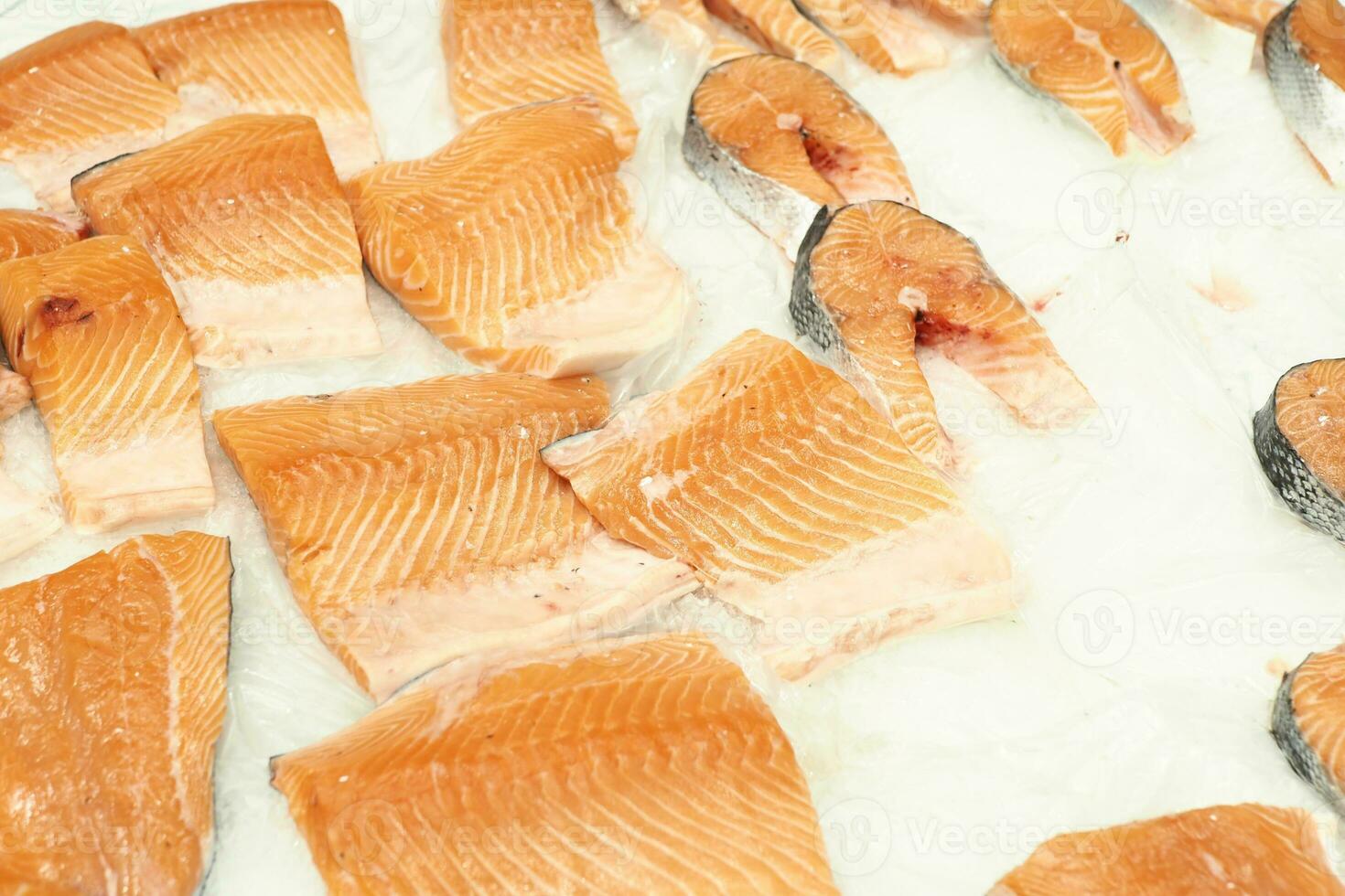 Raw, fresh salmon steak on ice cube photo