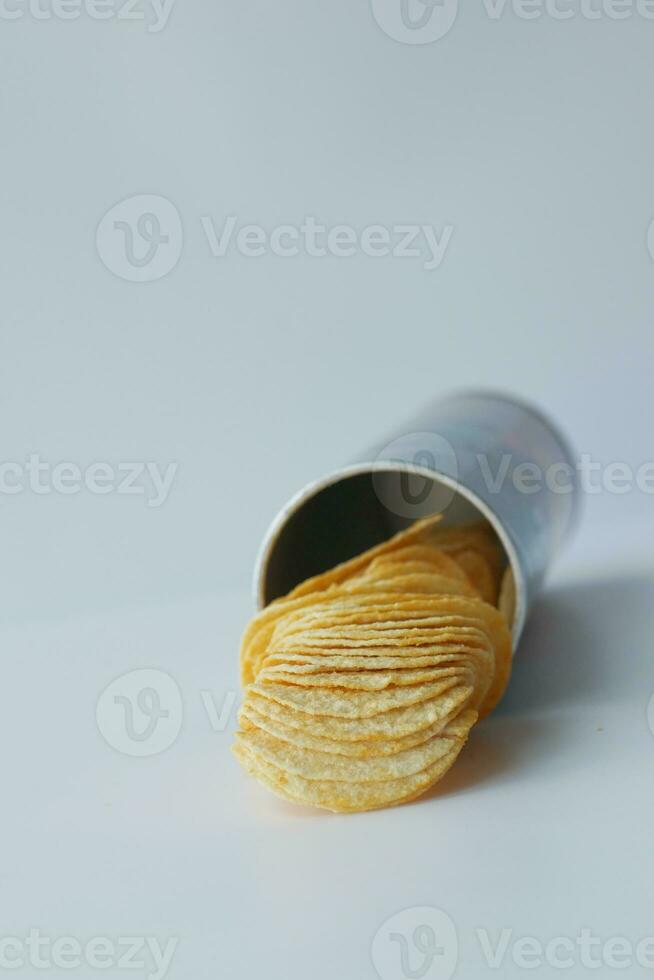 potato chips spilling form a packet on table photo