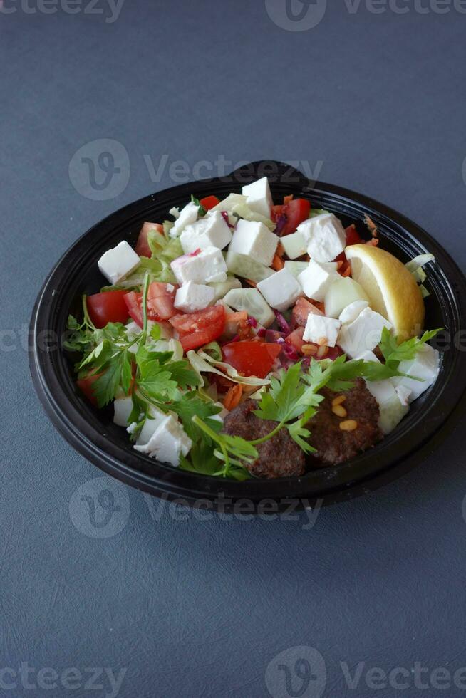 greek salad in a bowl on table. photo