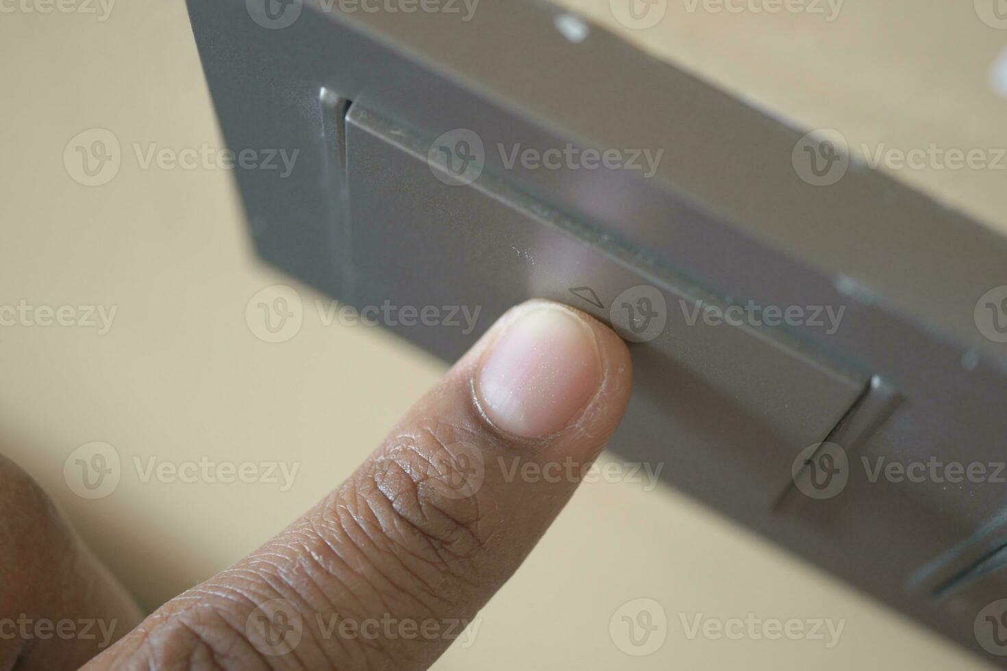 A finger turning on lighting switch . photo