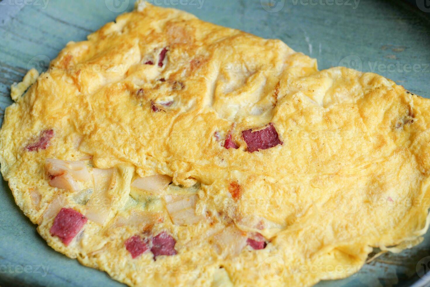 Plain Egg Omelette with salami on table photo