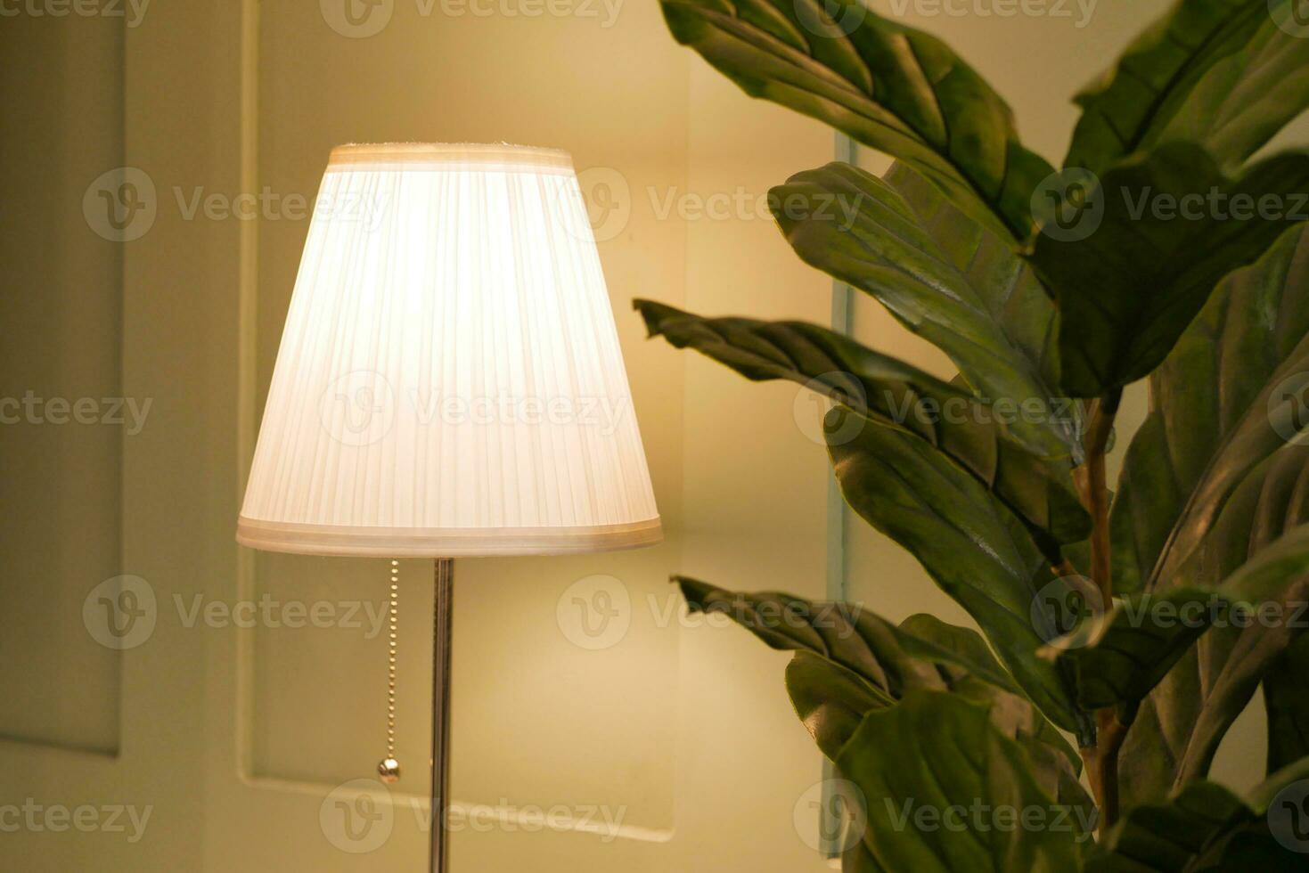 a lamp in home against white wall photo