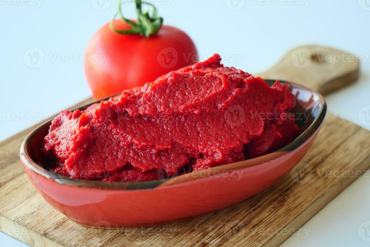 Tomato paste with ripe tomatoes. photo