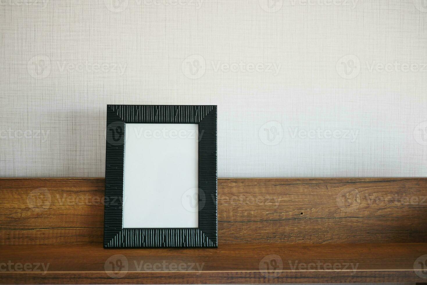 empty frame on table against a wall photo