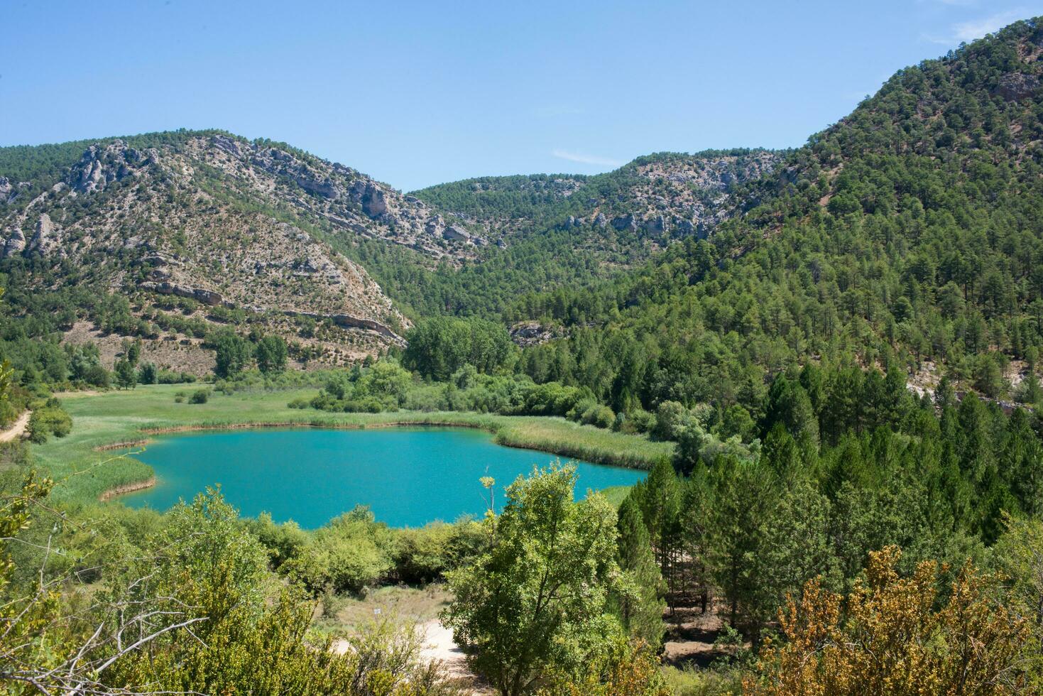 Beautiful landscape with mountains forest, and turquoise lake. Guadalajara, Spain photo