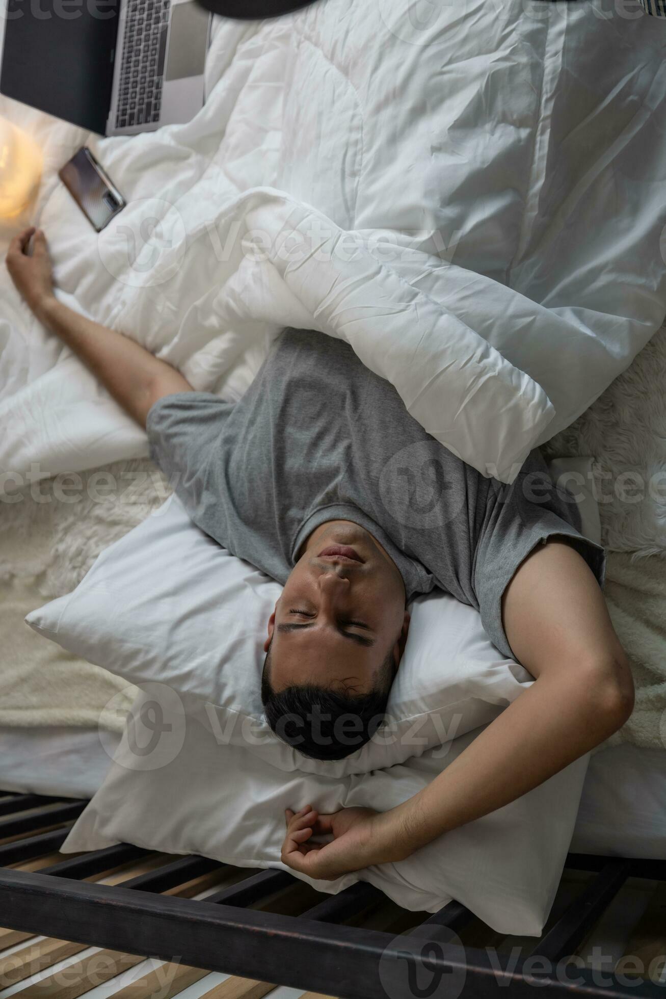 Lazy man oversleep, wake up late, hit the alarm clock frequently with