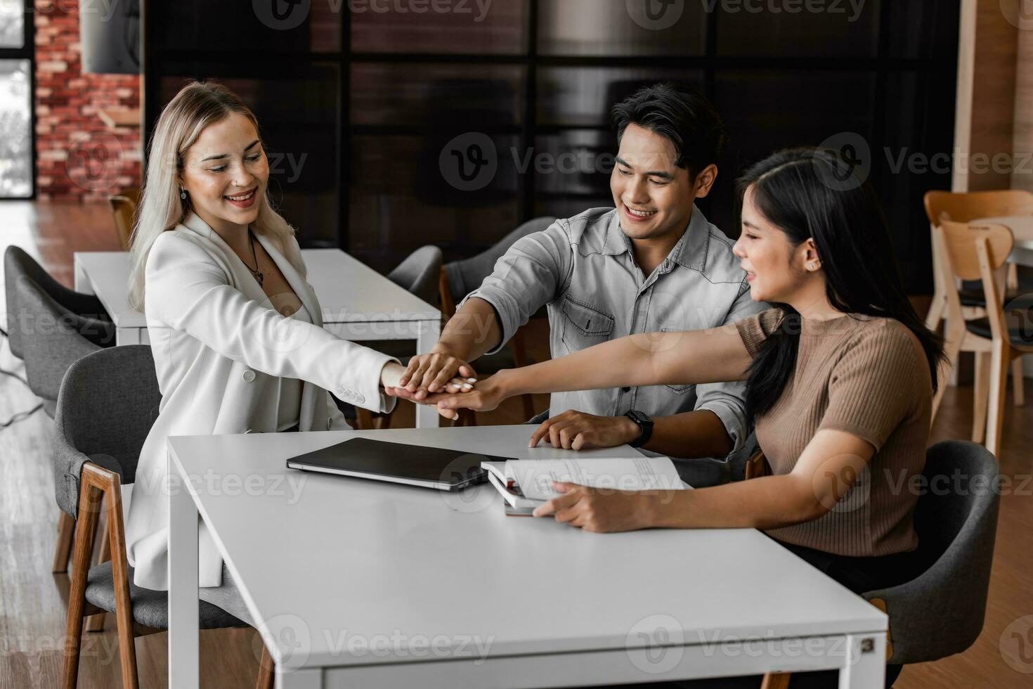 College students join study groups in the academic library to work on team building and project assignments. Collaborative brainstorming, thinking. Celebrating project success and outstanding results photo