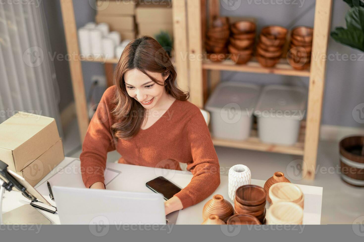 Vase brand owner processes online orders. Response to customer queries and concerns about products and shipment to increase long term loyalty and satisfaction. Routine work of e commerce entrepreneur photo