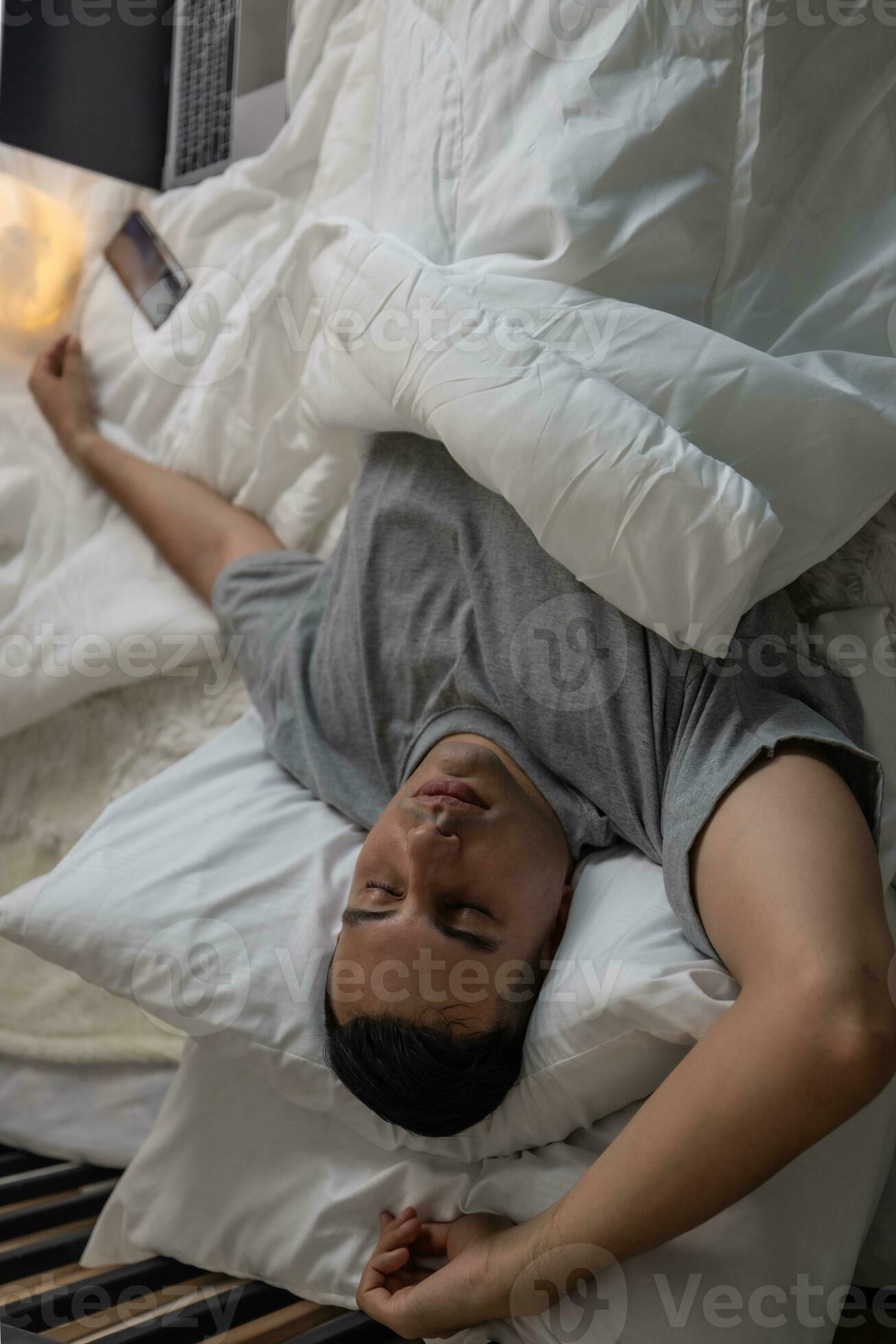 Lazy man oversleep, wake up late, hit the alarm clock frequently with