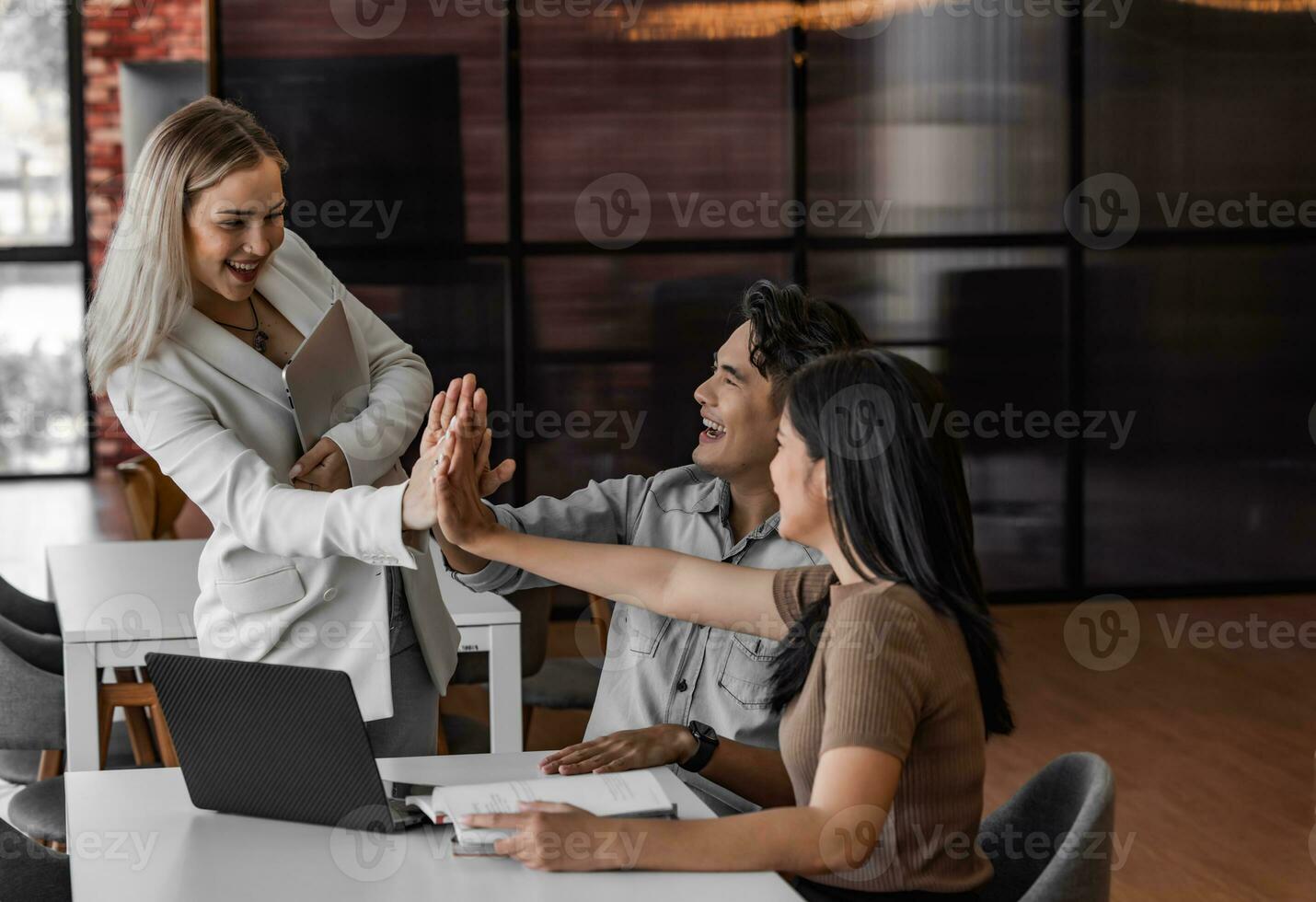 College students join study groups in the academic library to work on team building and project assignments. Collaborative brainstorming, thinking. Celebrating project success and outstanding results photo