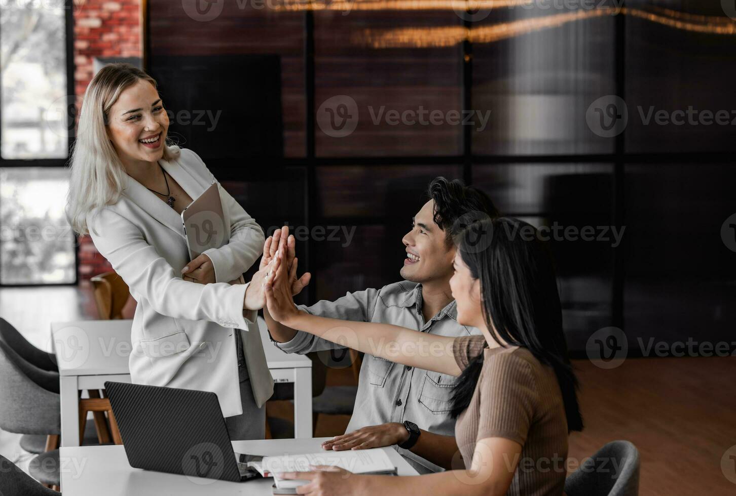 College students join study groups in the academic library to work on team building and project assignments. Collaborative brainstorming, thinking. Celebrating project success and outstanding results photo