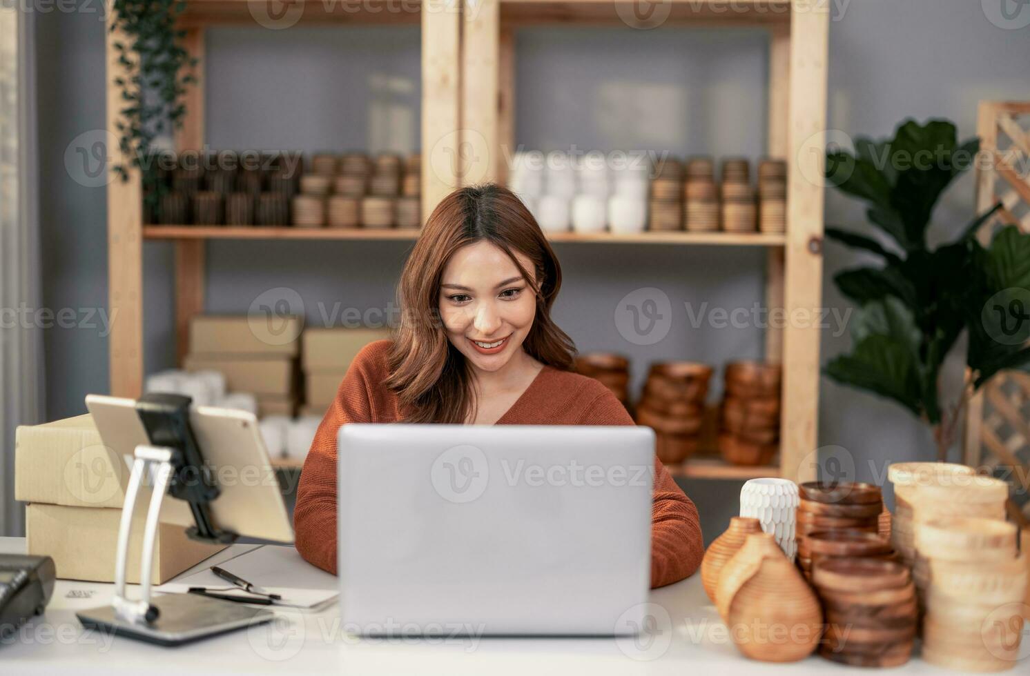 Vase brand owner processes online orders. Response to customer queries and concerns about products and shipment to increase long term loyalty and satisfaction. Routine work of e commerce entrepreneur photo