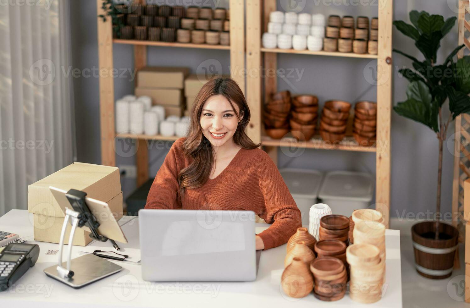 Vase brand owner processes online orders. Response to customer queries and concerns about products and shipment to increase long term loyalty and satisfaction. Routine work of e commerce entrepreneur photo