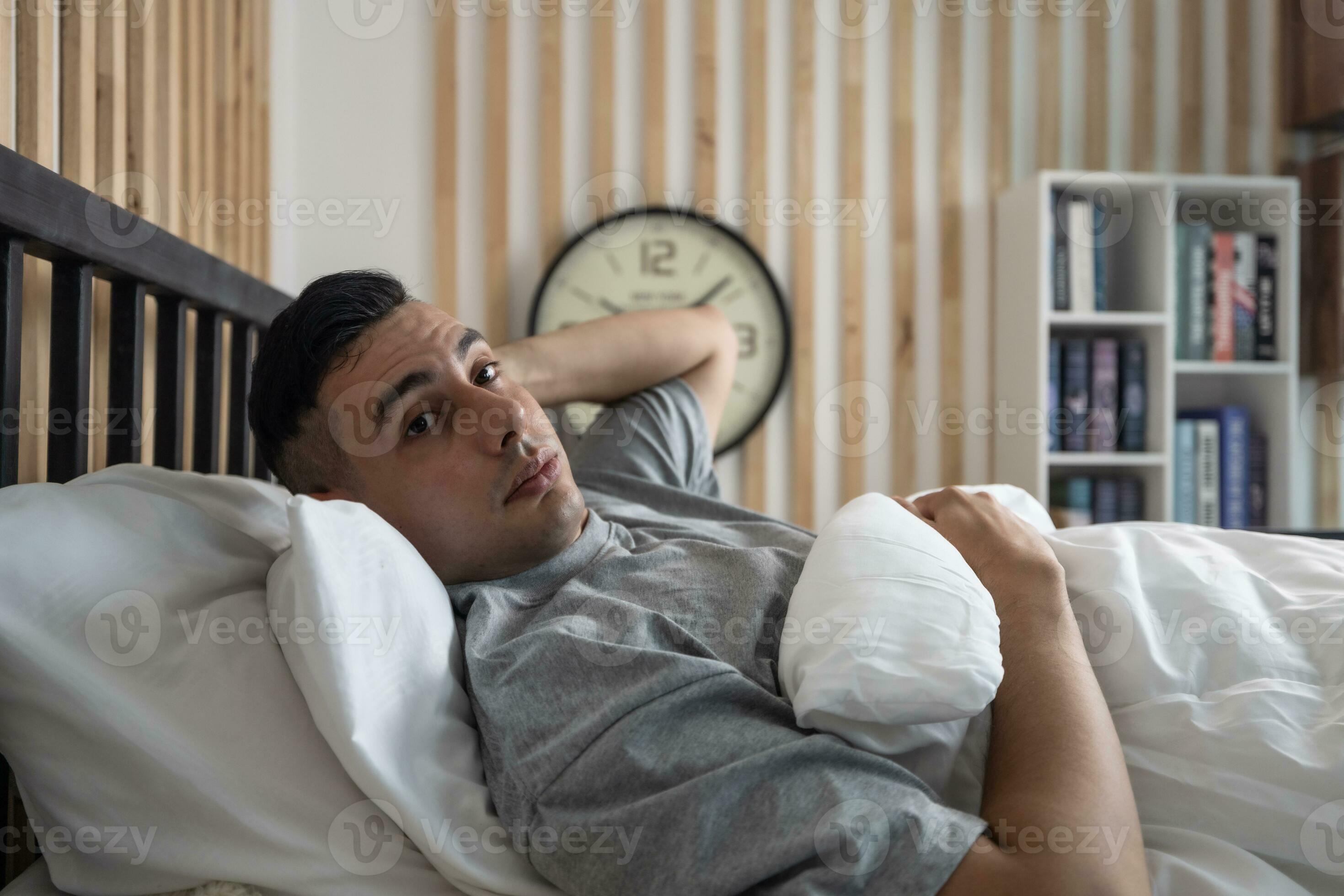 Lazy man oversleep, wake up late, hit the alarm clock frequently with