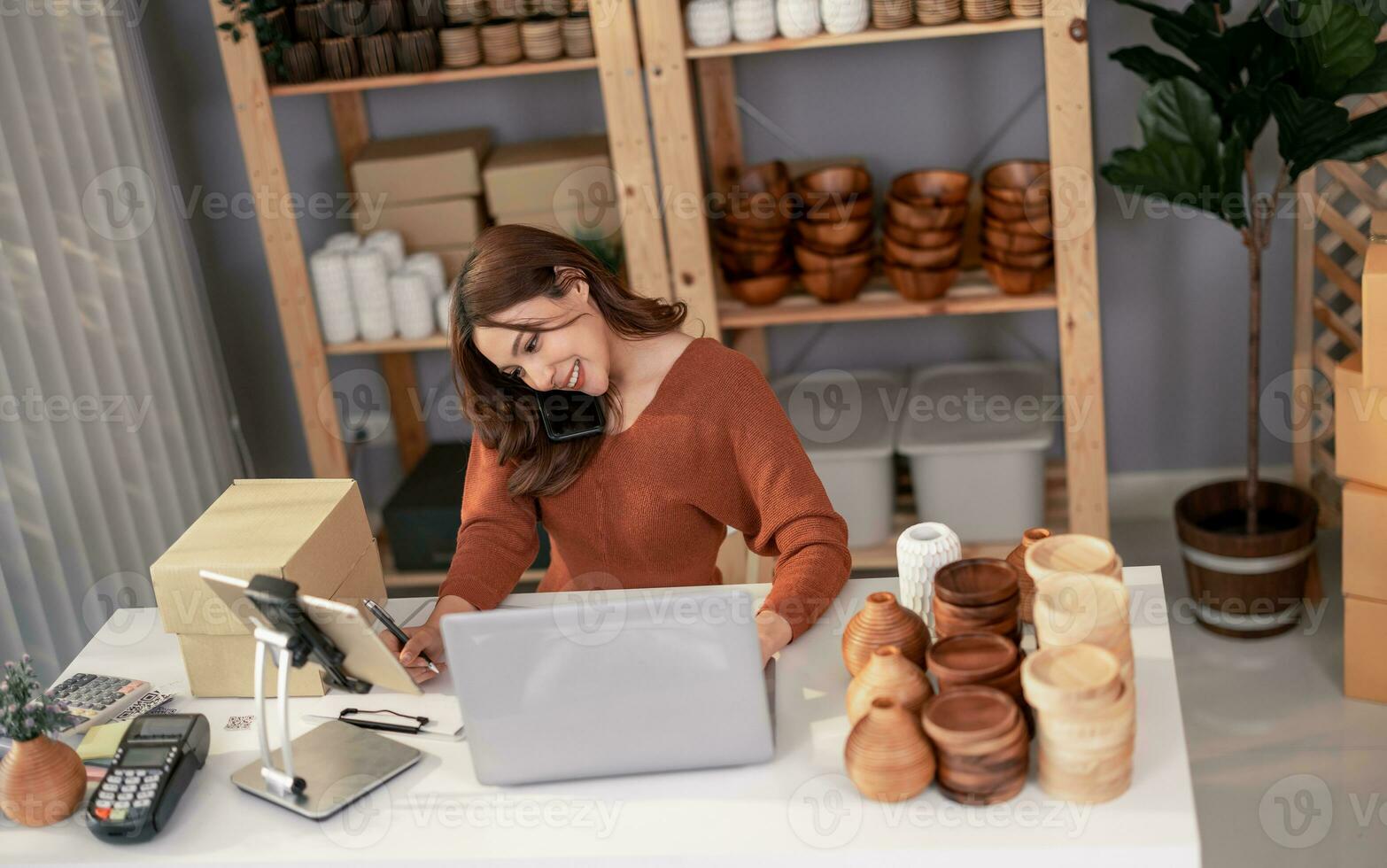 Vase brand owner processes online orders. Response to customer queries and concerns about products and shipment to increase long term loyalty and satisfaction. Routine work of e commerce entrepreneur photo