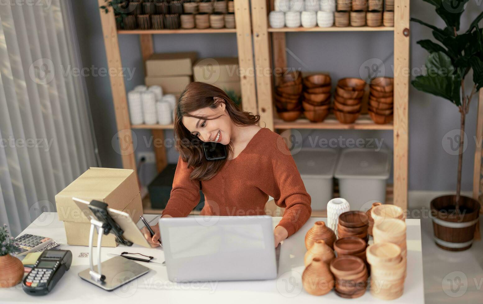 Vase brand owner processes online orders. Response to customer queries and concerns about products and shipment to increase long term loyalty and satisfaction. Routine work of e commerce entrepreneur photo