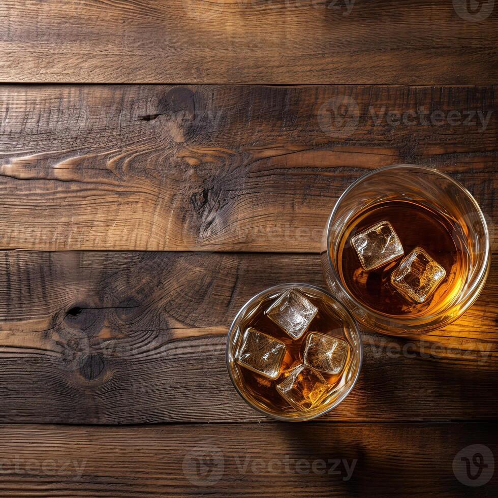 Glass of whiskey and barrel on wooden background top view. photo