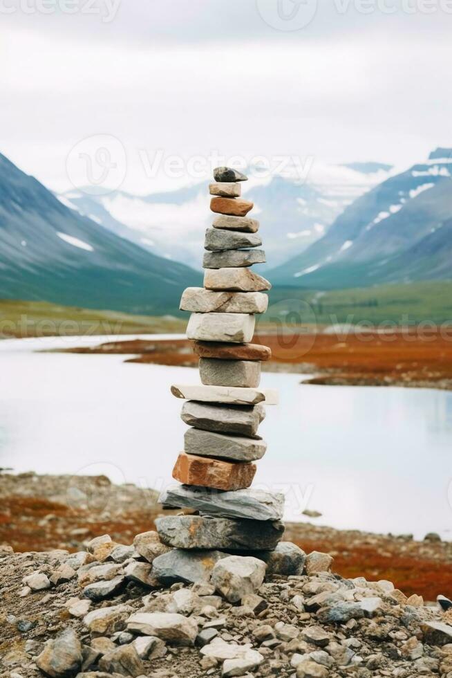 un minimalista inukshuk hecho de apilado piedras señalando el camino a través de el Alaska tundra. ai generativo foto