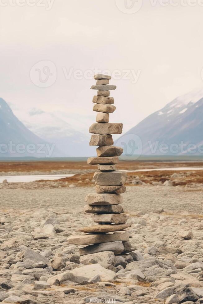 A minimalist Inukshuk made of piled stones pointing the way across the Alaskan tundra. photo