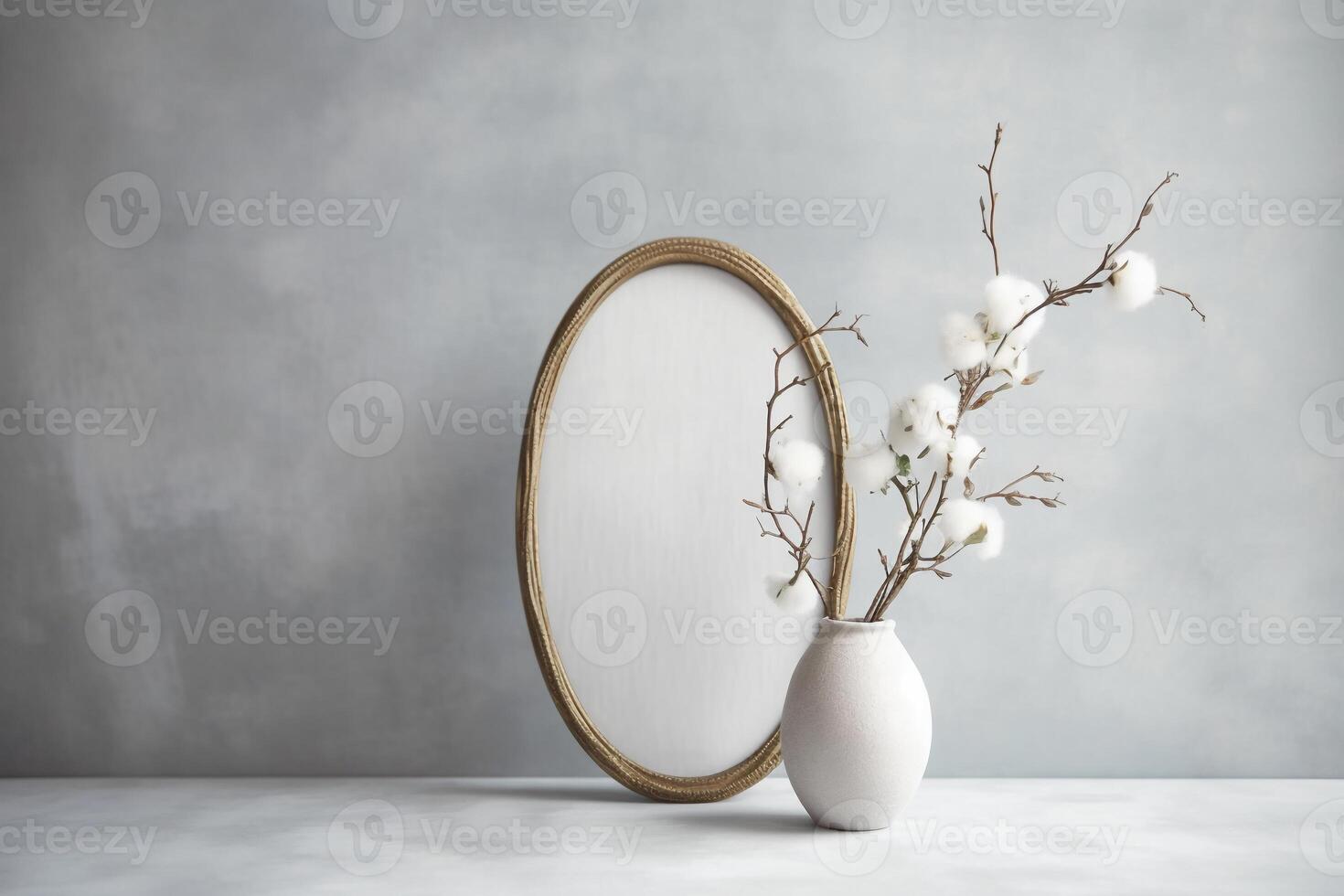 Front view product photo of white oval frame with wild Cotton branches in glass vase behind the frame.