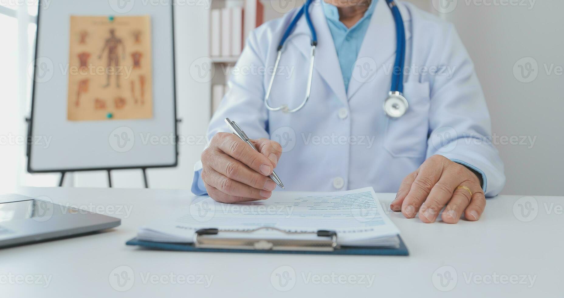 Mature Asian male doctor talking with his patient, explaining the procedure to old lady. photo