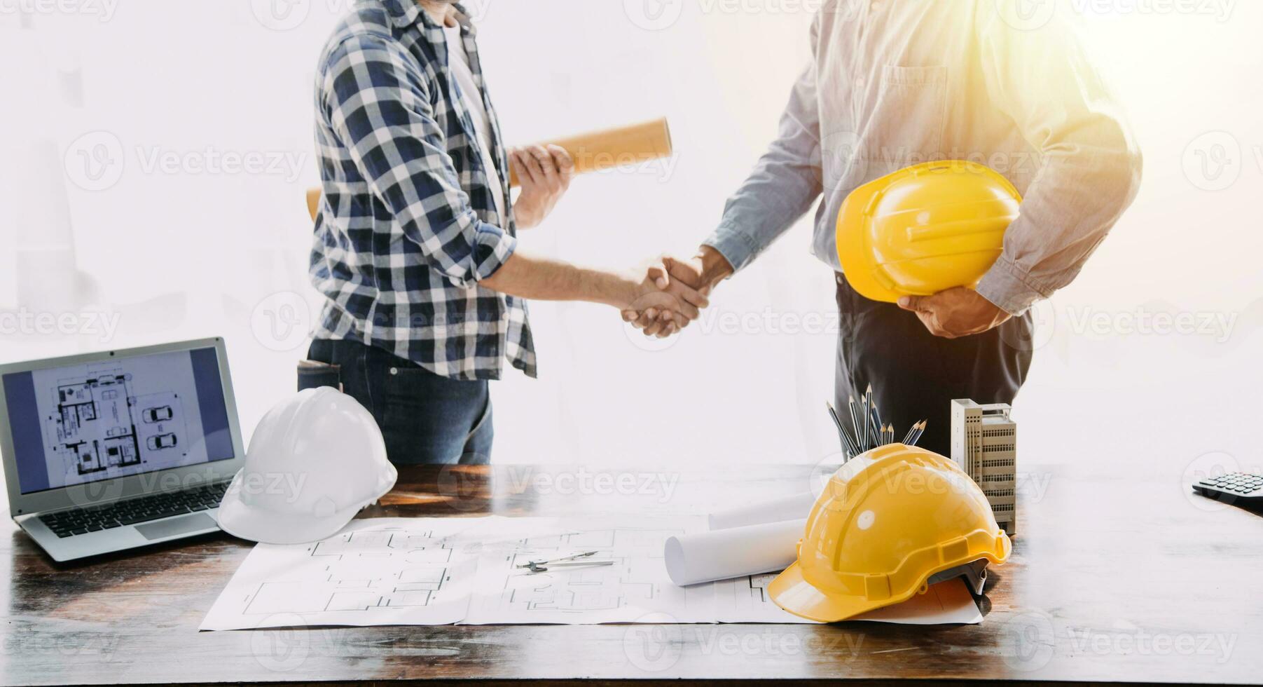 Construction and structure concept of Engineer or architect meeting for project working with partner and engineering tools on model building and blueprint in working site, contract for both companies. photo