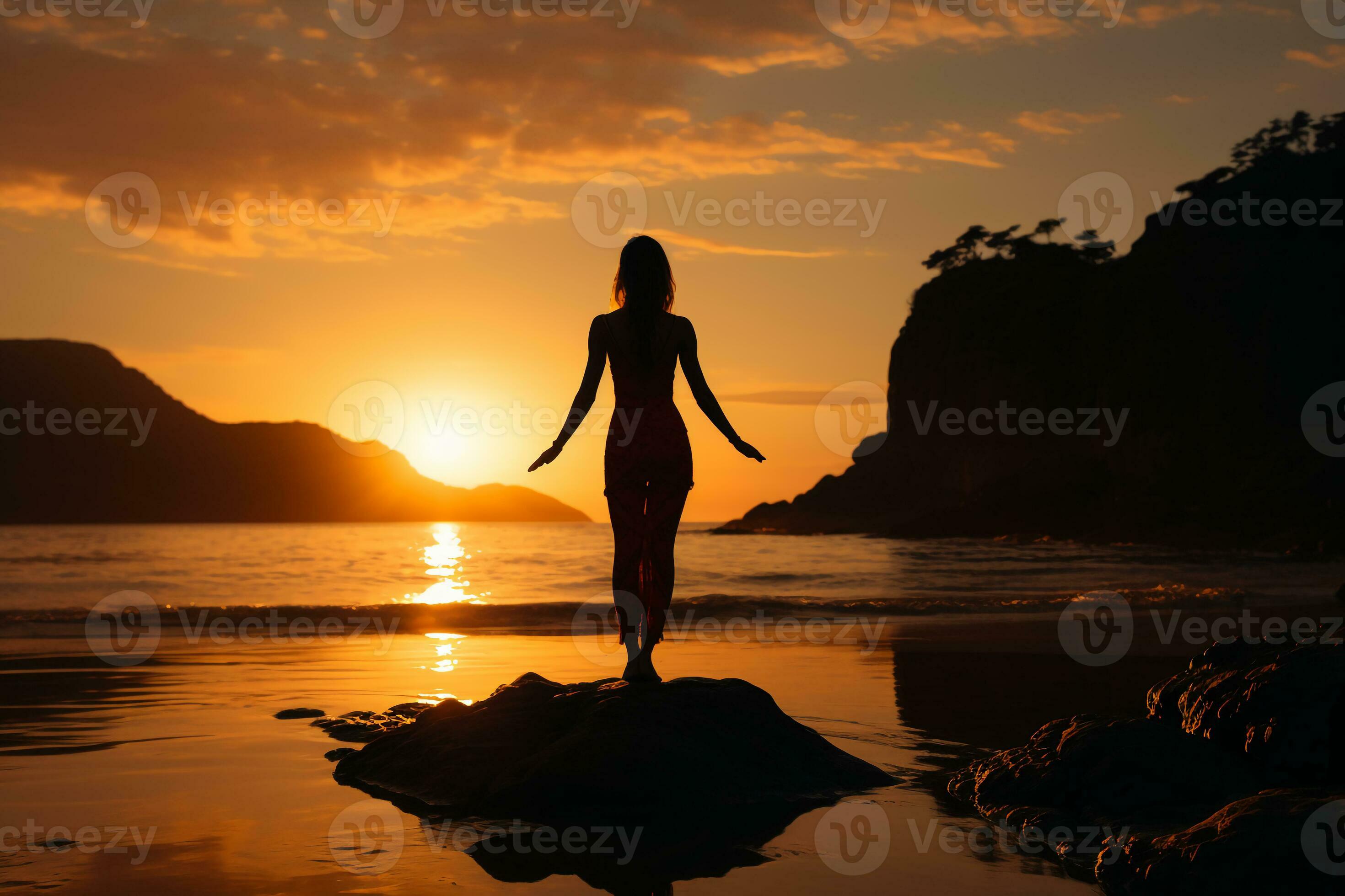 Silhouette Of Woman Standing At Yoga Pose On The Beach During An