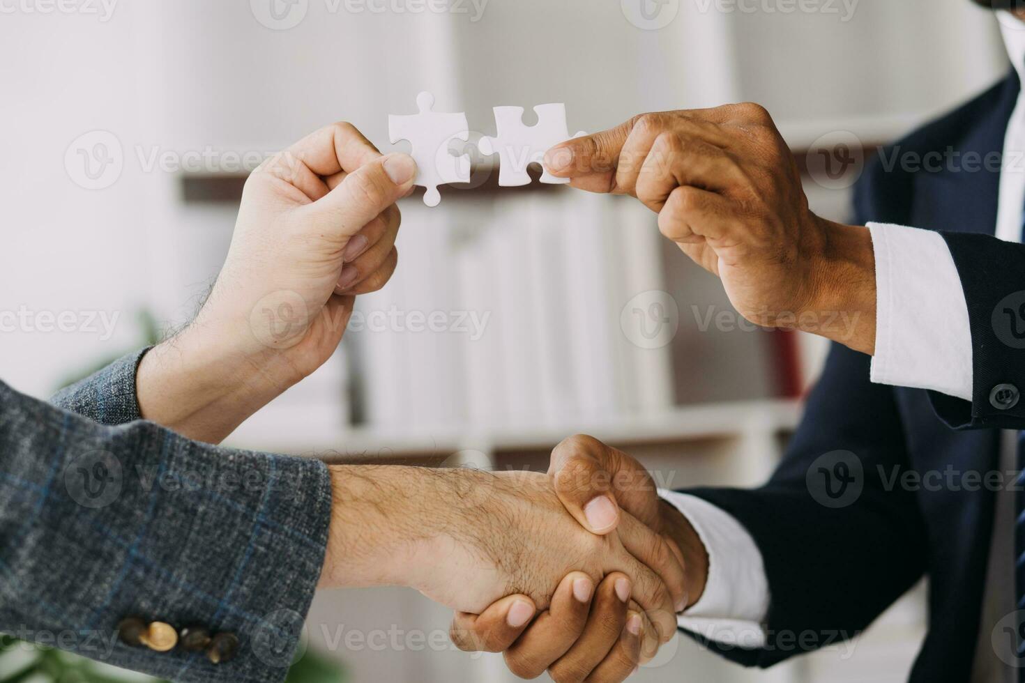 Image of business partners handshaking over business objects on workplace photo