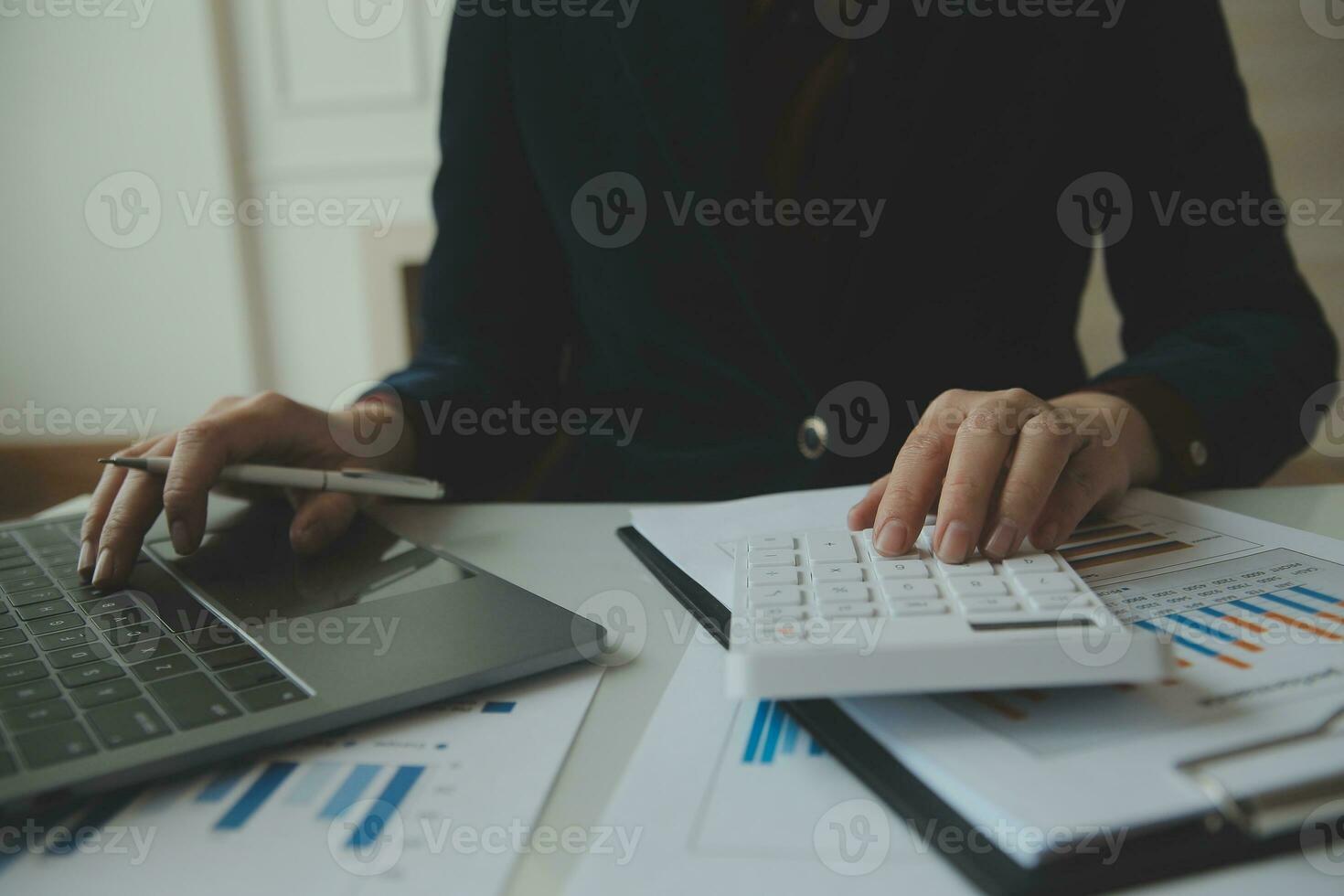 Close up businessman hand using calculator and working with laptop calculate about finance accounting at coffeeshop outdor.finance accounting concept photo