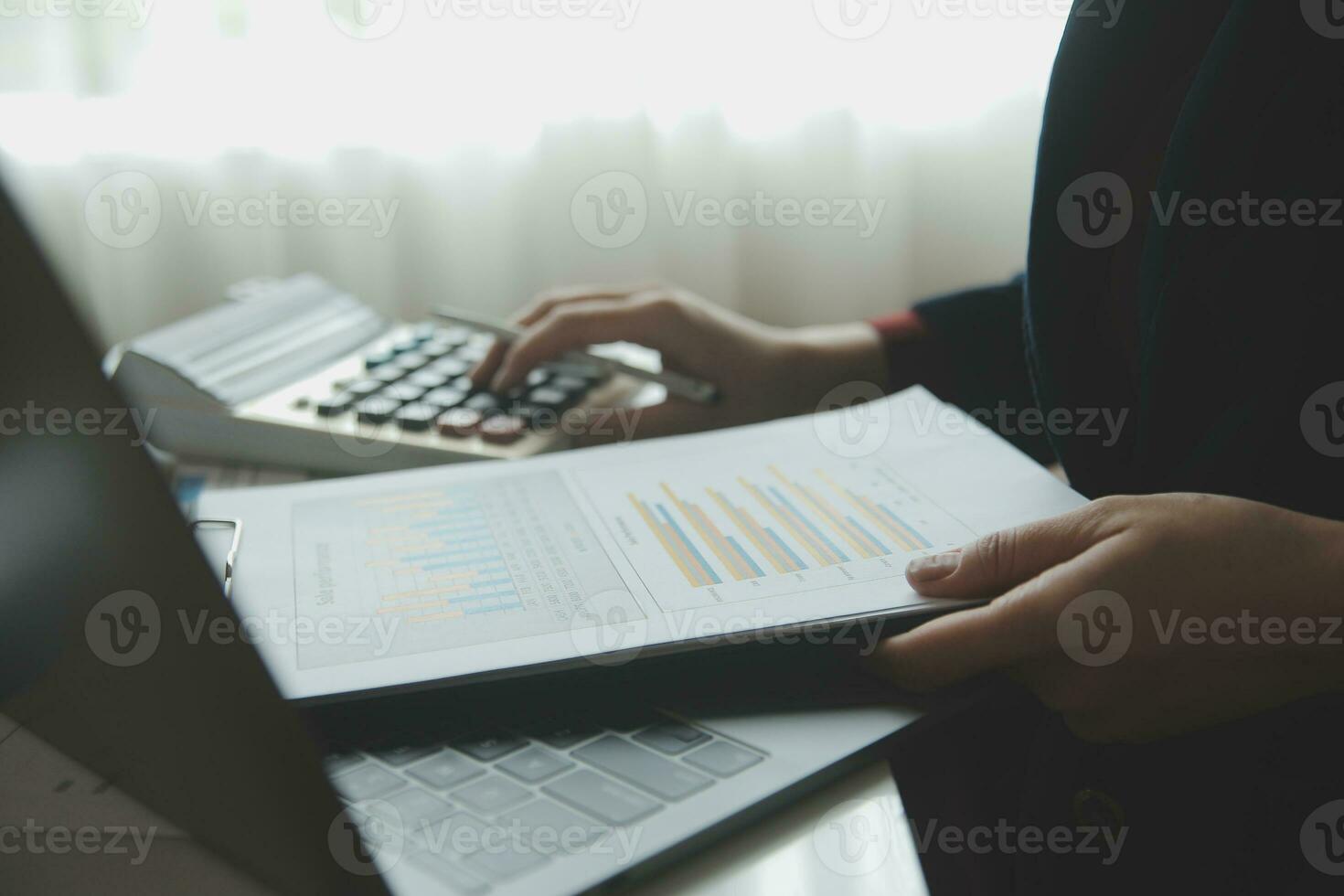 Close up businessman hand using calculator and working with laptop calculate about finance accounting at coffeeshop outdor.finance accounting concept photo
