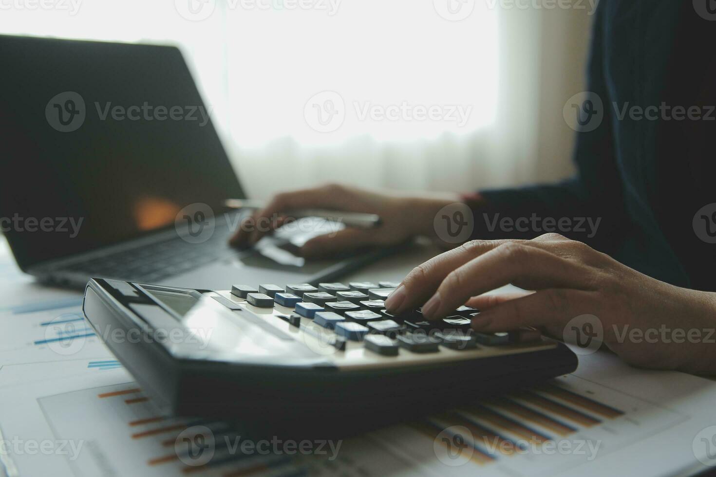Close up businessman hand using calculator and working with laptop calculate about finance accounting at coffeeshop outdor.finance accounting concept photo