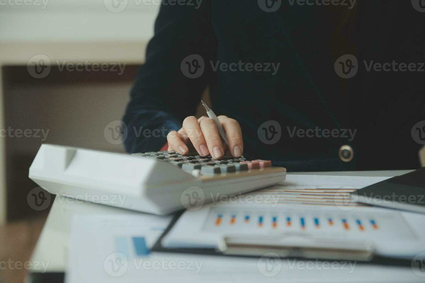 Close up businessman hand using calculator and working with laptop calculate about finance accounting at coffeeshop outdor.finance accounting concept photo