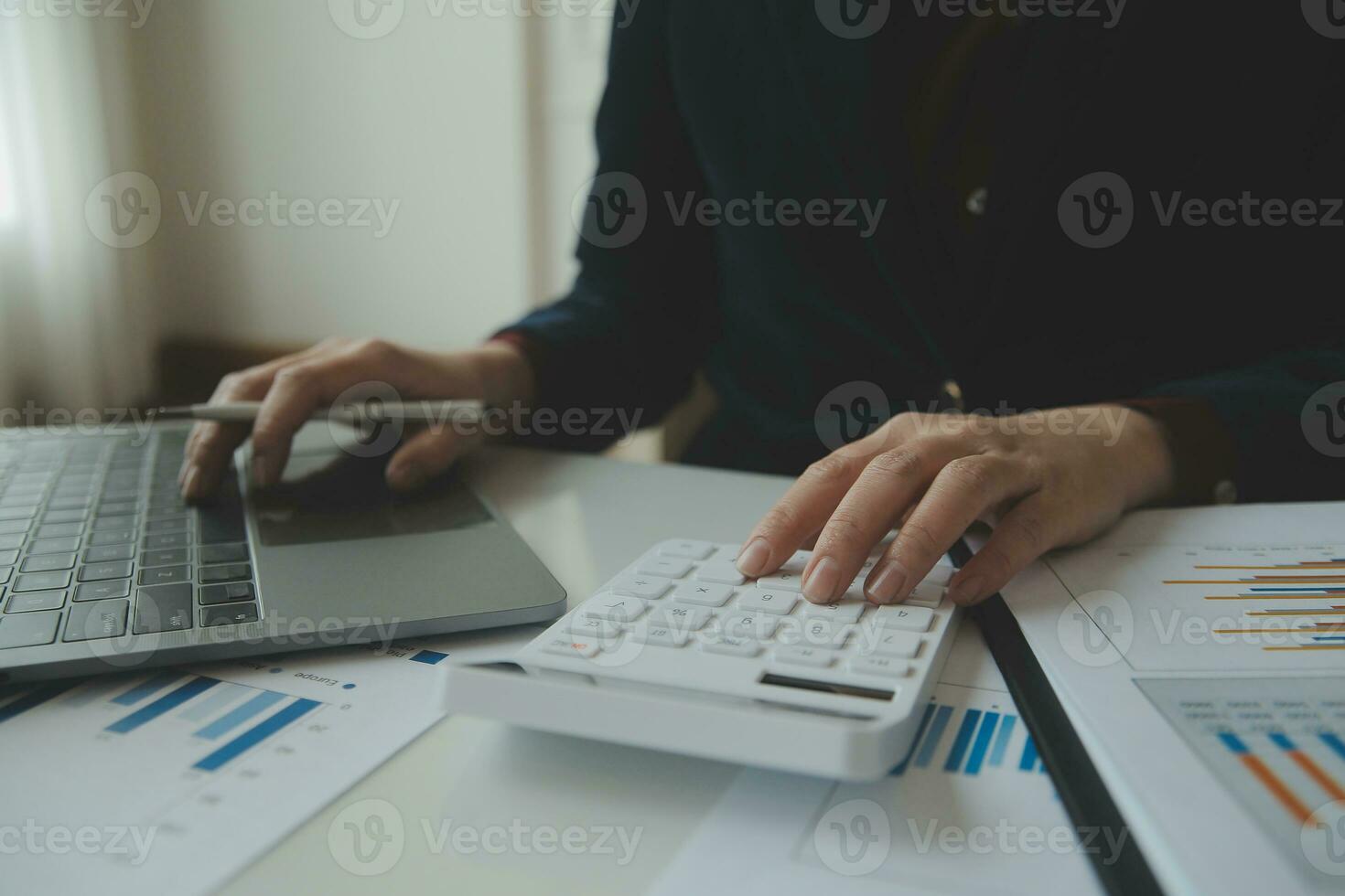 Close up businessman hand using calculator and working with laptop calculate about finance accounting at coffeeshop outdor.finance accounting concept photo