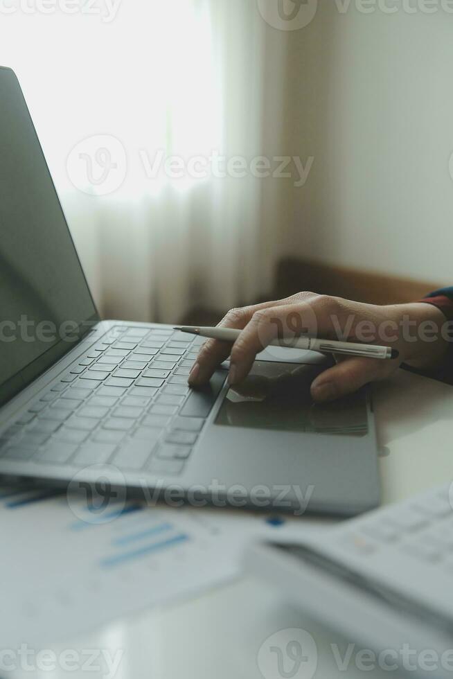 Unrecognizable businessman using calculator photo