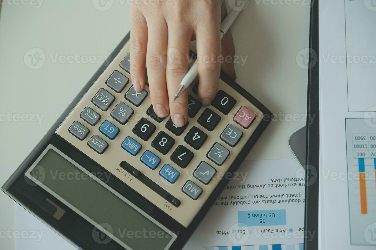 Unrecognizable businessman using calculator photo