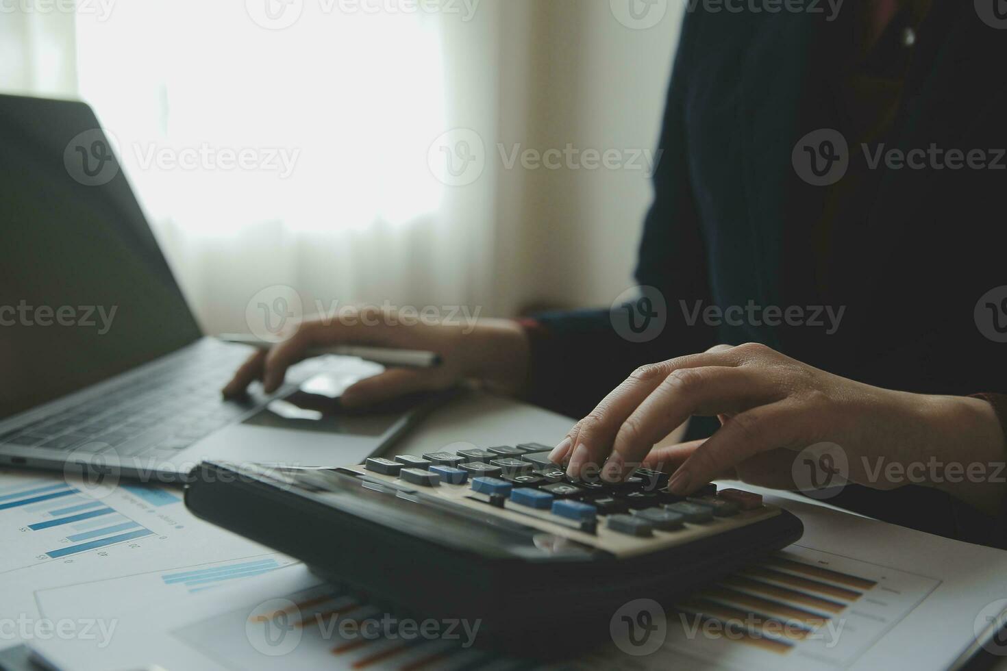 Unrecognizable businessman using calculator photo