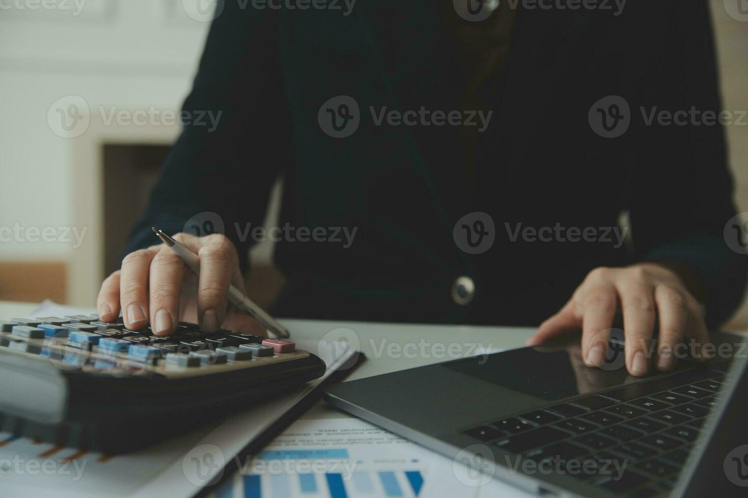 Unrecognizable businessman using calculator photo