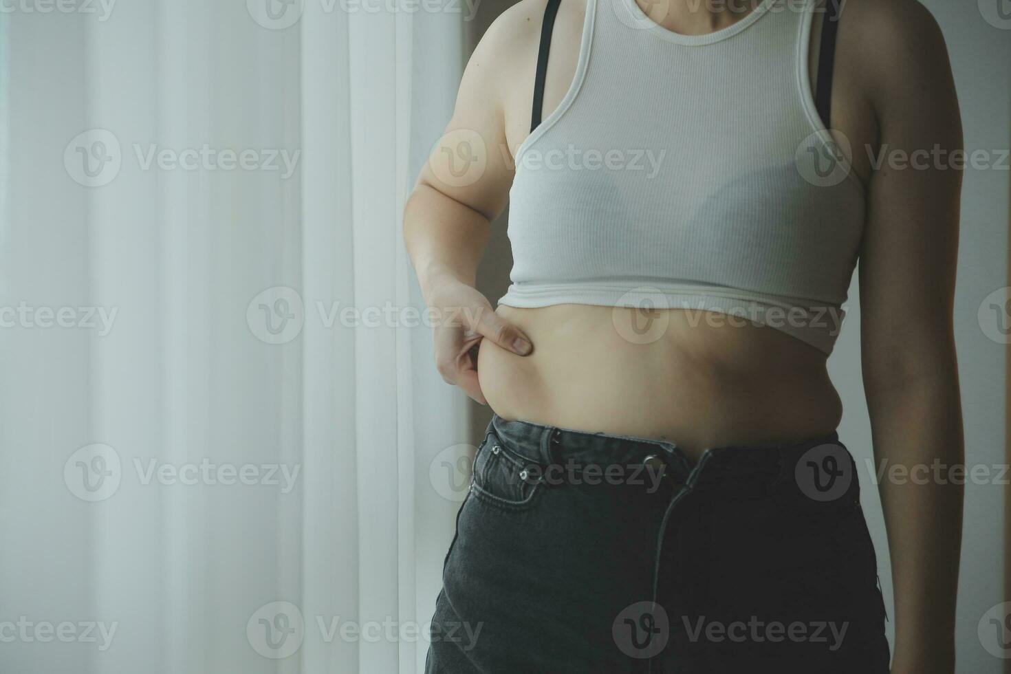 fat woman, fat belly, chubby, obese woman hand holding excessive belly fat with measure tape, woman diet lifestyle concept photo