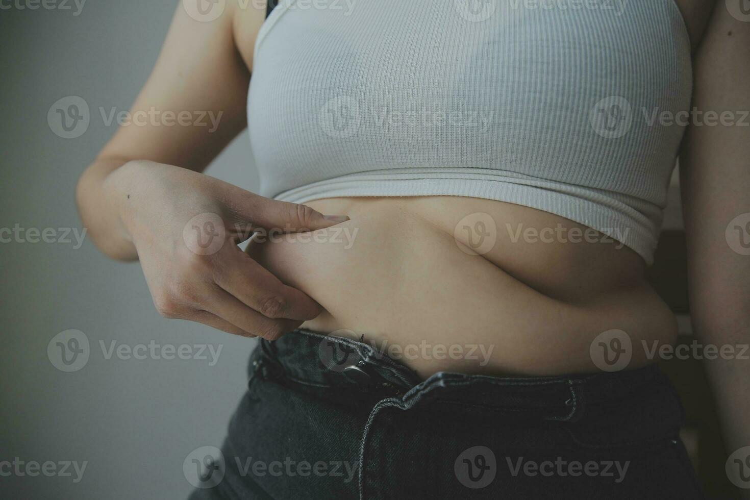 fat woman, fat belly, chubby, obese woman hand holding excessive belly fat with measure tape, woman diet lifestyle concept photo