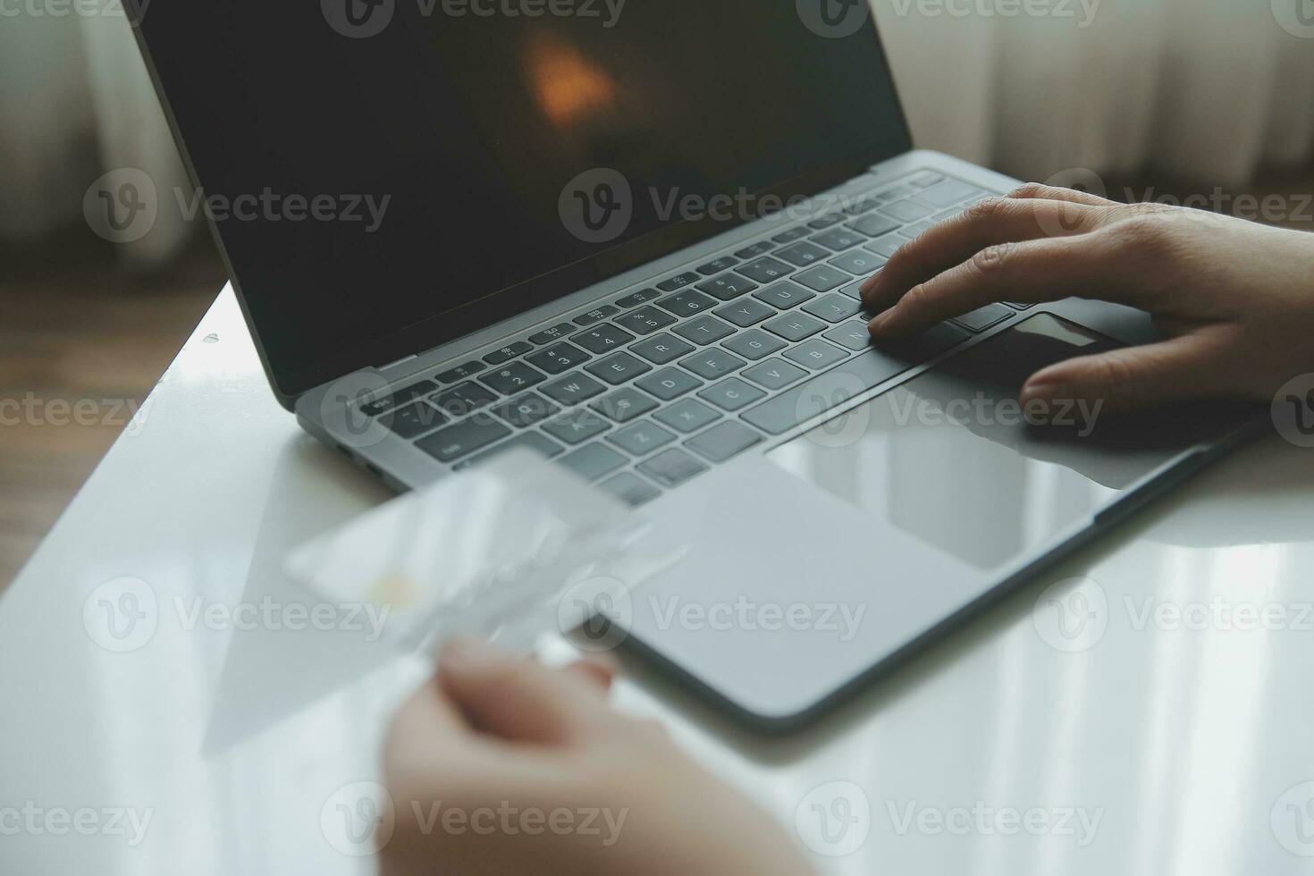 Woman hands holding and using cradit card for shopping online. photo