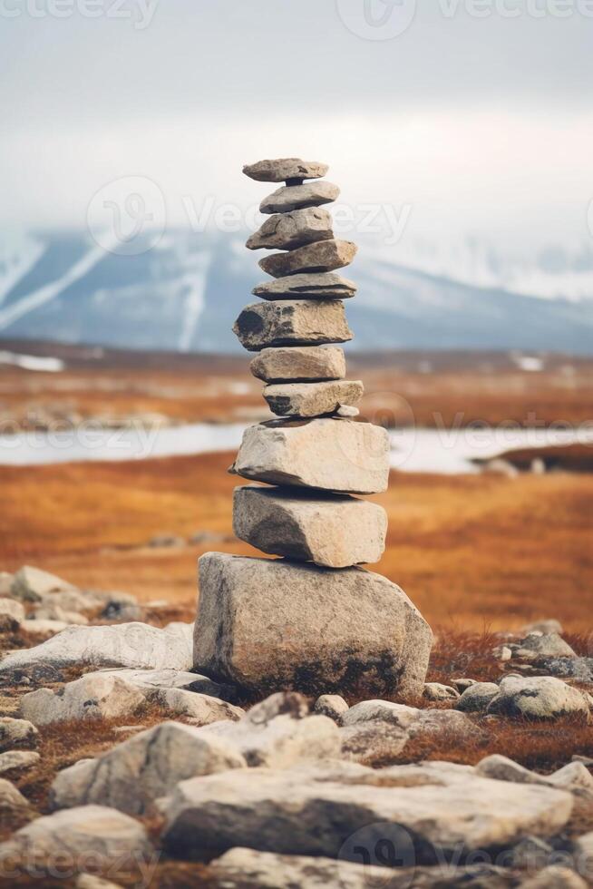 A minimalist Inukshuk made of piled stones pointing the way across the Alaskan tundra. photo