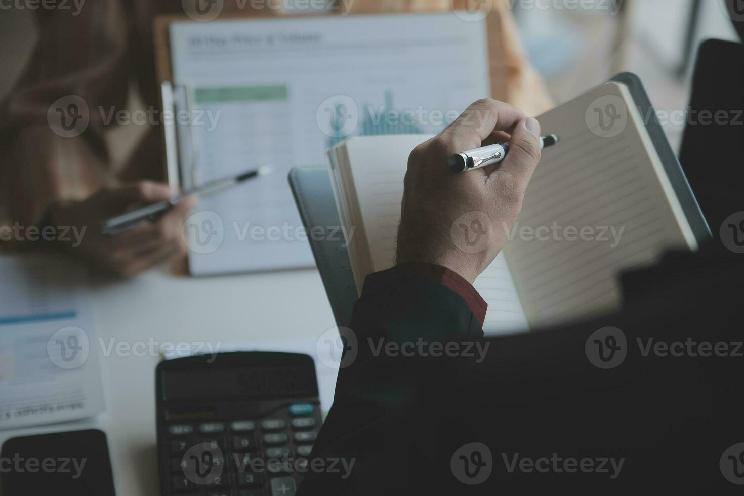Asian Business woman using calculator and laptop for doing math finance on an office desk, tax, report, accounting, statistics, and analytical research concept photo