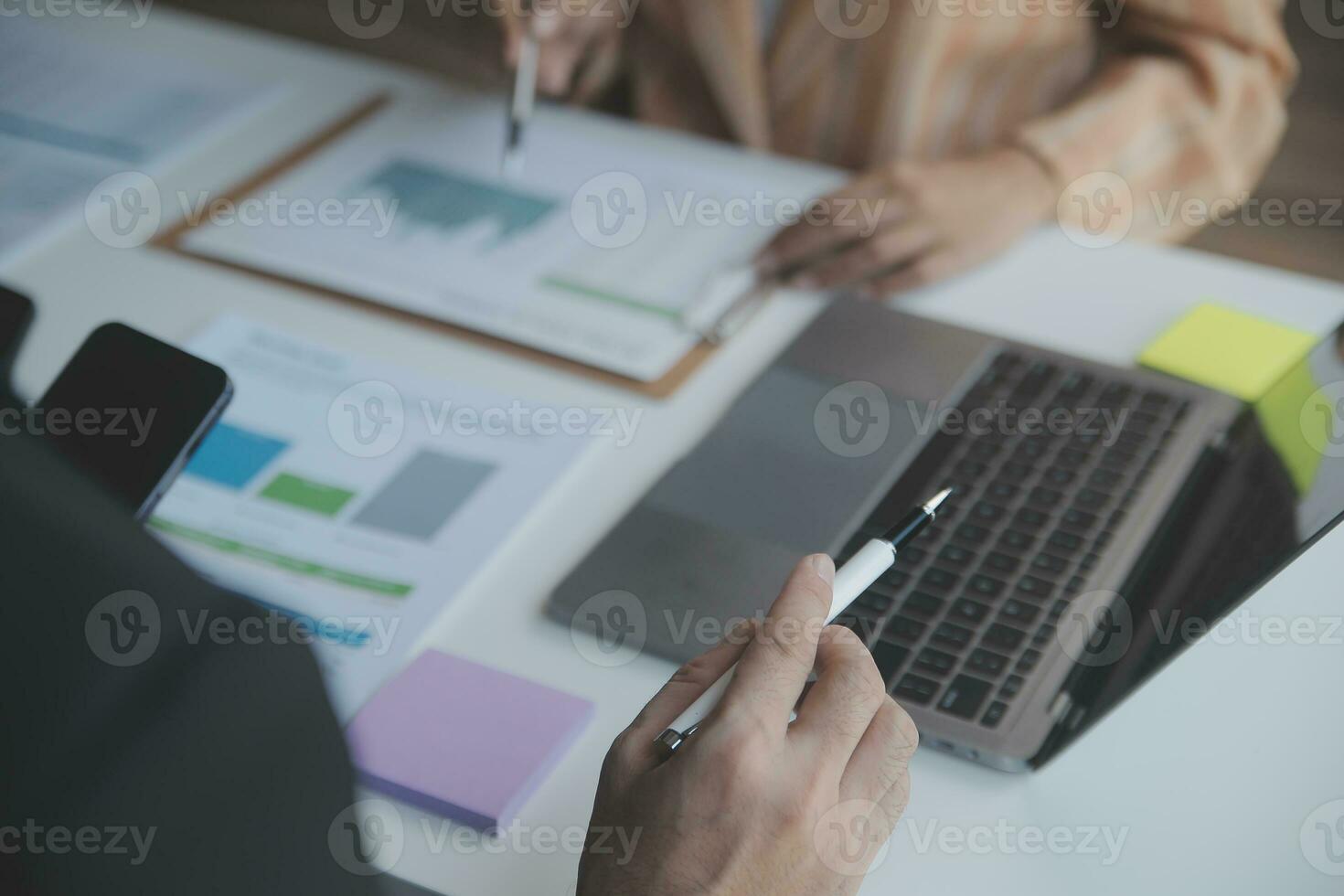 Asian Business woman using calculator and laptop for doing math finance on an office desk, tax, report, accounting, statistics, and analytical research concept photo